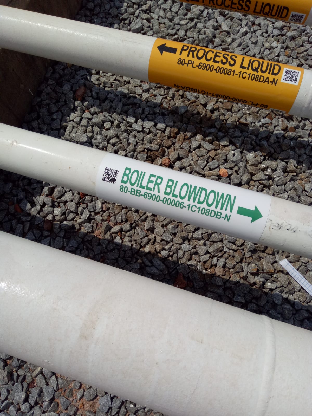 Self-adhesive pipe identification labels with high-visibility text for industrial facilities
