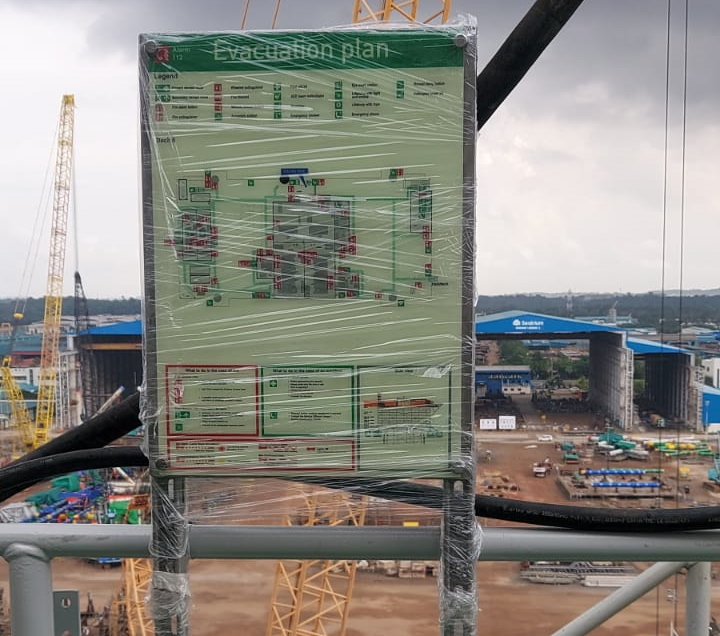 Fire evacuation and safety plan display boards with assembly point layouts and emergency procedures